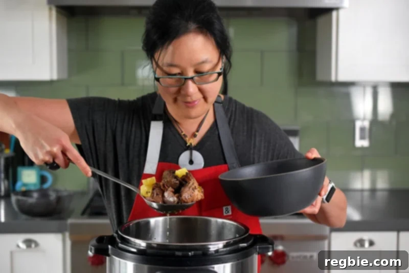 Ladling Instant Pot Spicy Pineapple Pork into a bowl.