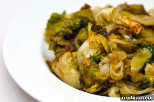 Caramelized Roasted Escarole 2 Oven-Roasted Escarole in a plate, garnished with balsamic vinegar.
