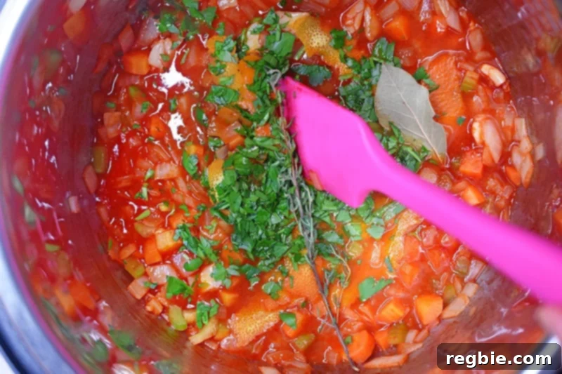 An overhead shot of an open Instant Pot containing the prepared paleo orange duck leg mixture before cooking.