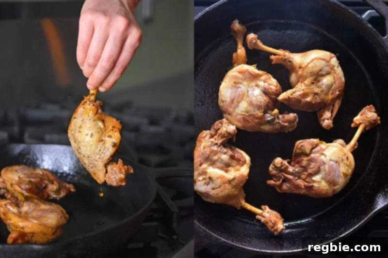 Frying Instant Pot orange duck legs in a cast iron skillet to achieve crispy skin.