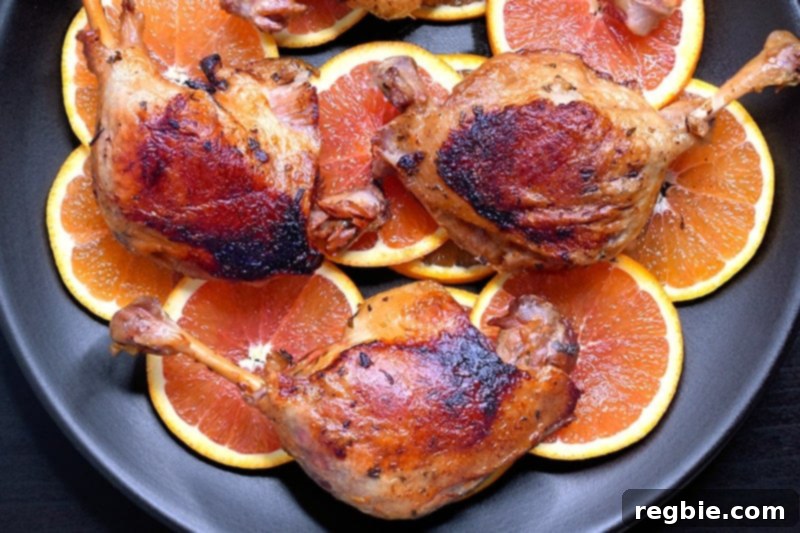 An overhead shot of a platter topped with Instant Pot (Pressure Cooker) Orange Duck legs, ready to be served.
