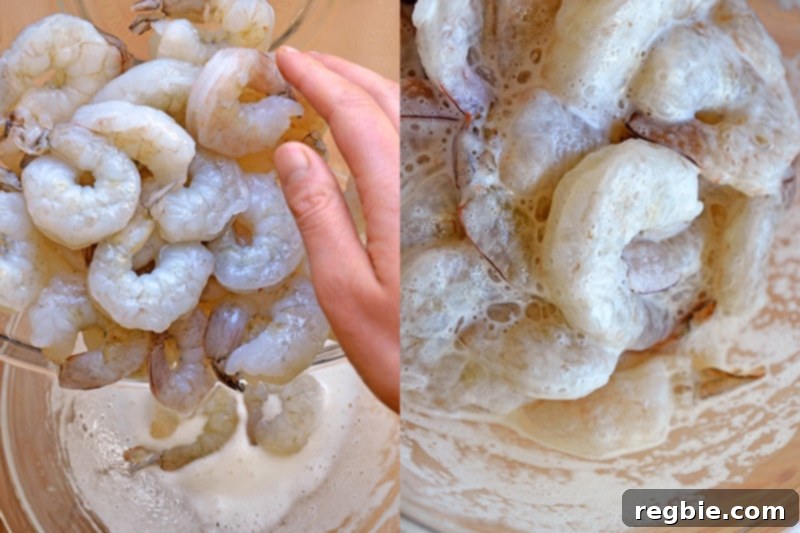 Adding the raw shrimp to a bowl of smooth batter, ensuring full coverage for our Paleo Walnut Shrimp.