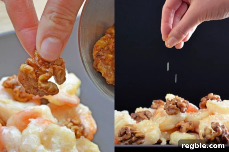 Adding the maple spiced walnuts and toasted sesame seeds to a platter of finished Paleo Walnut Shrimp.