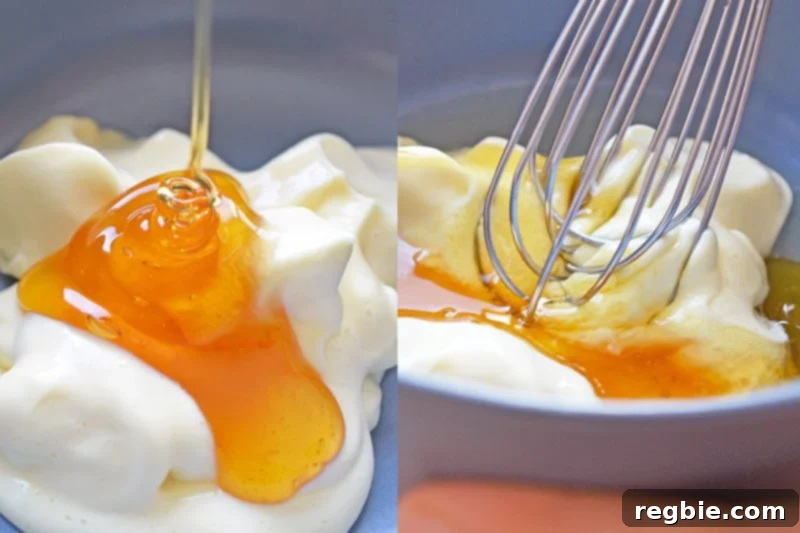 Whisking together the Paleo mayonnaise and honey in a bowl, creating the base for the creamy sauce.
