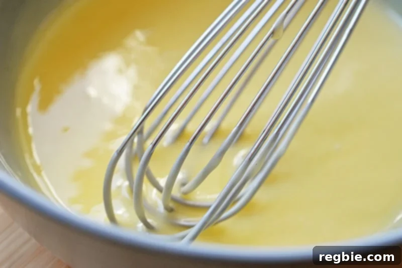 An overhead shot of a bowl filled with the light yellow, perfectly smooth and creamy sauce for Paleo Walnut Shrimp.