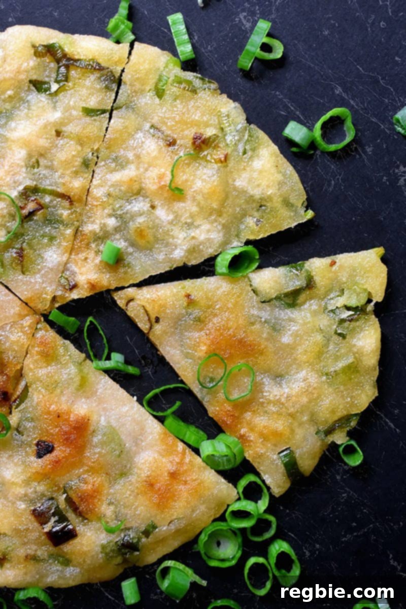 An overhead shot of a Paleo Scallion Pancake cut into wedges.