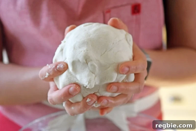 Forming the dough for Paleo Scallion Pancakes into a round ball.