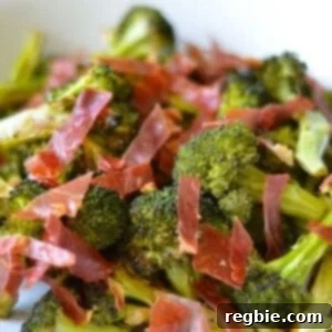 Roasted broccoli with crispy prosciutto and balsamic vinegar, garnished on a serving plate, ready to be enjoyed.