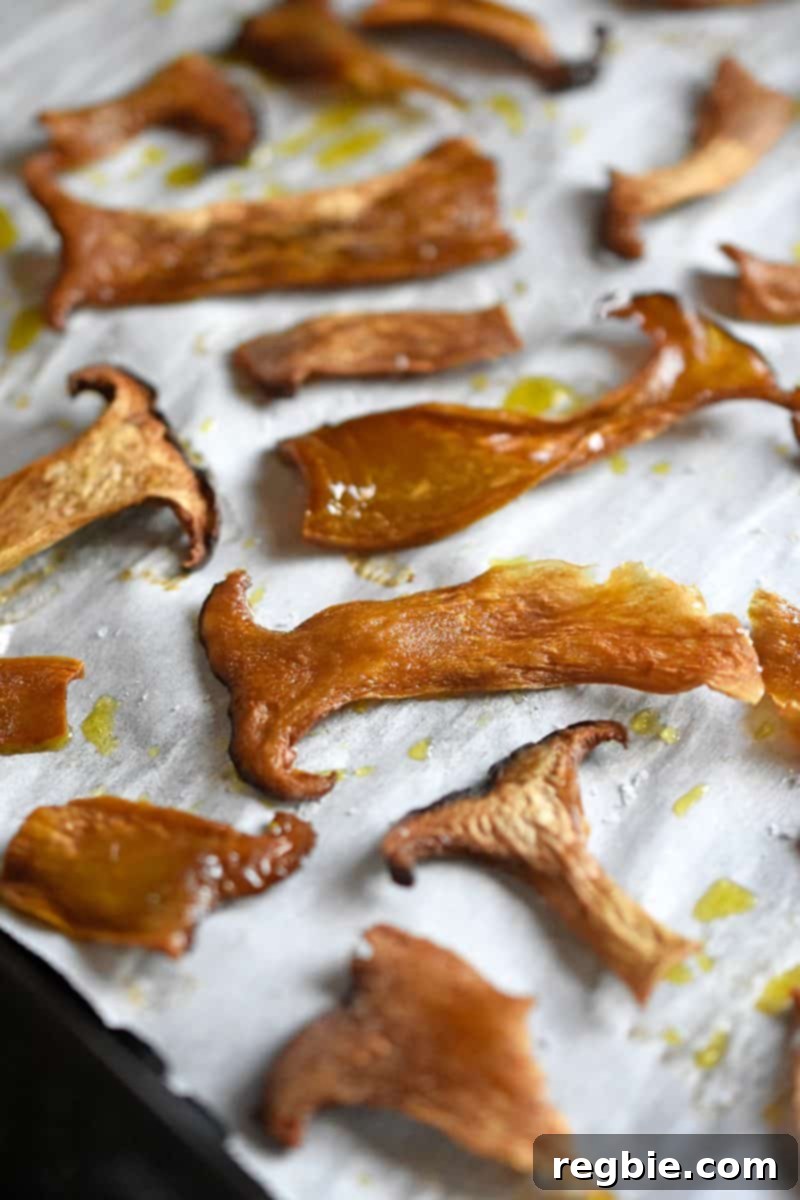 Thinly sliced mushrooms on a sheet tray baked and crisped.