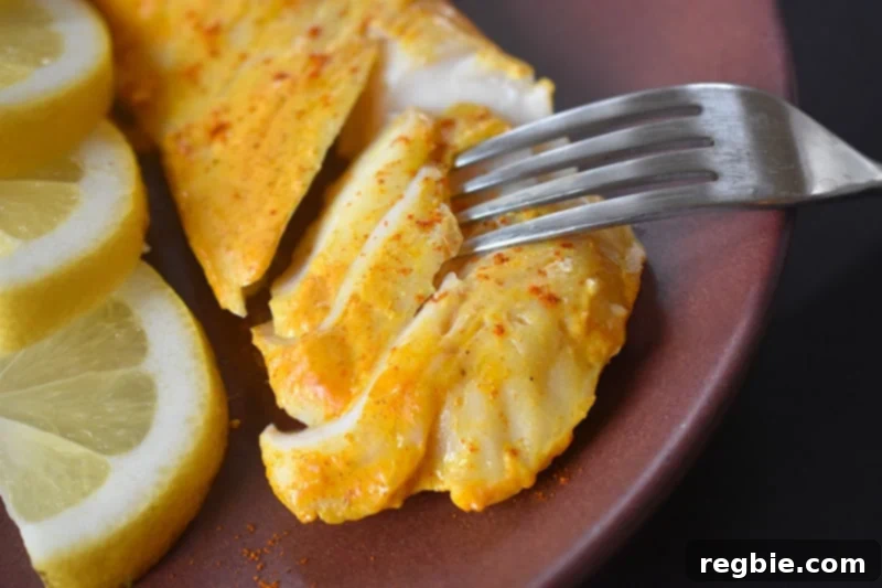 Tandoori Fish is easily flaked with a fork, demonstrating its perfect tenderness and doneness.