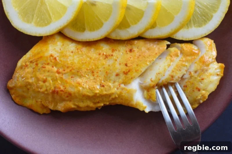 An overhead shot of Tandoori Fish on a plate with sliced lemons, ready to be enjoyed with a fresh side dish.