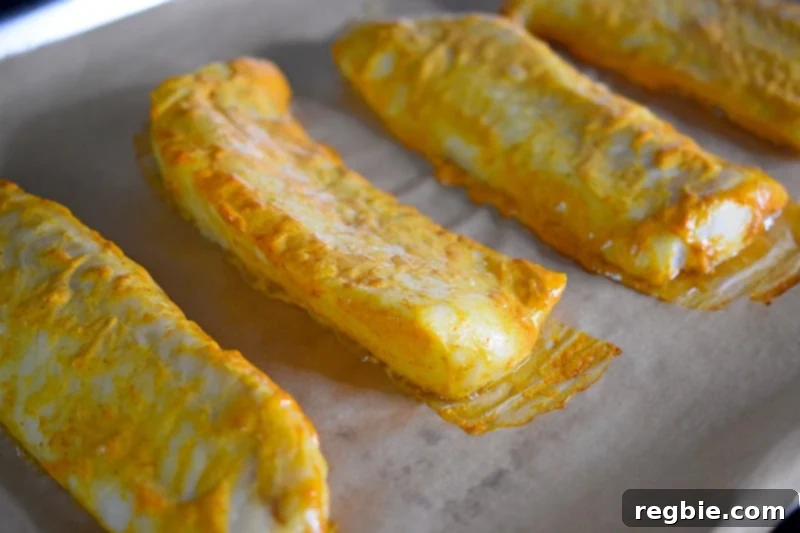 Tandoori Fish right out of the oven, showcasing a beautiful golden exterior and perfectly cooked texture.