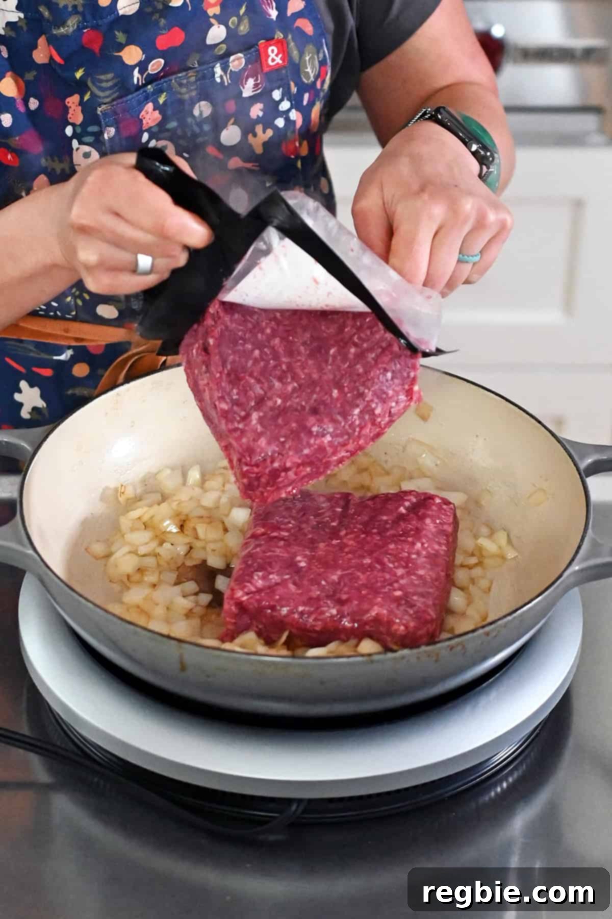 One-Pan Ground Beef and Veggie Power Bowl 5 Adding ground beef to skillet with onions