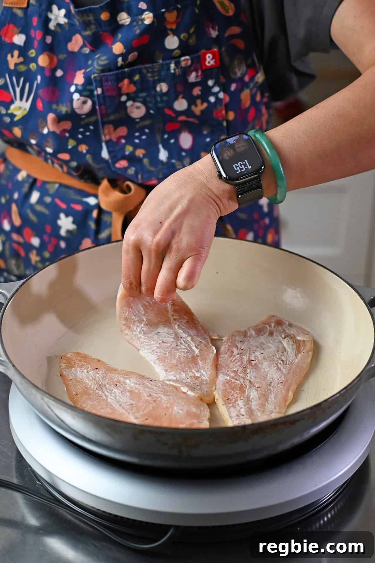 How I Cook Juicy, Tender Chicken Breasts Every Time 9 Adding a boneless skinless chicken breast coated with a thin layer of mayonnaise and seasoning into a skillet.