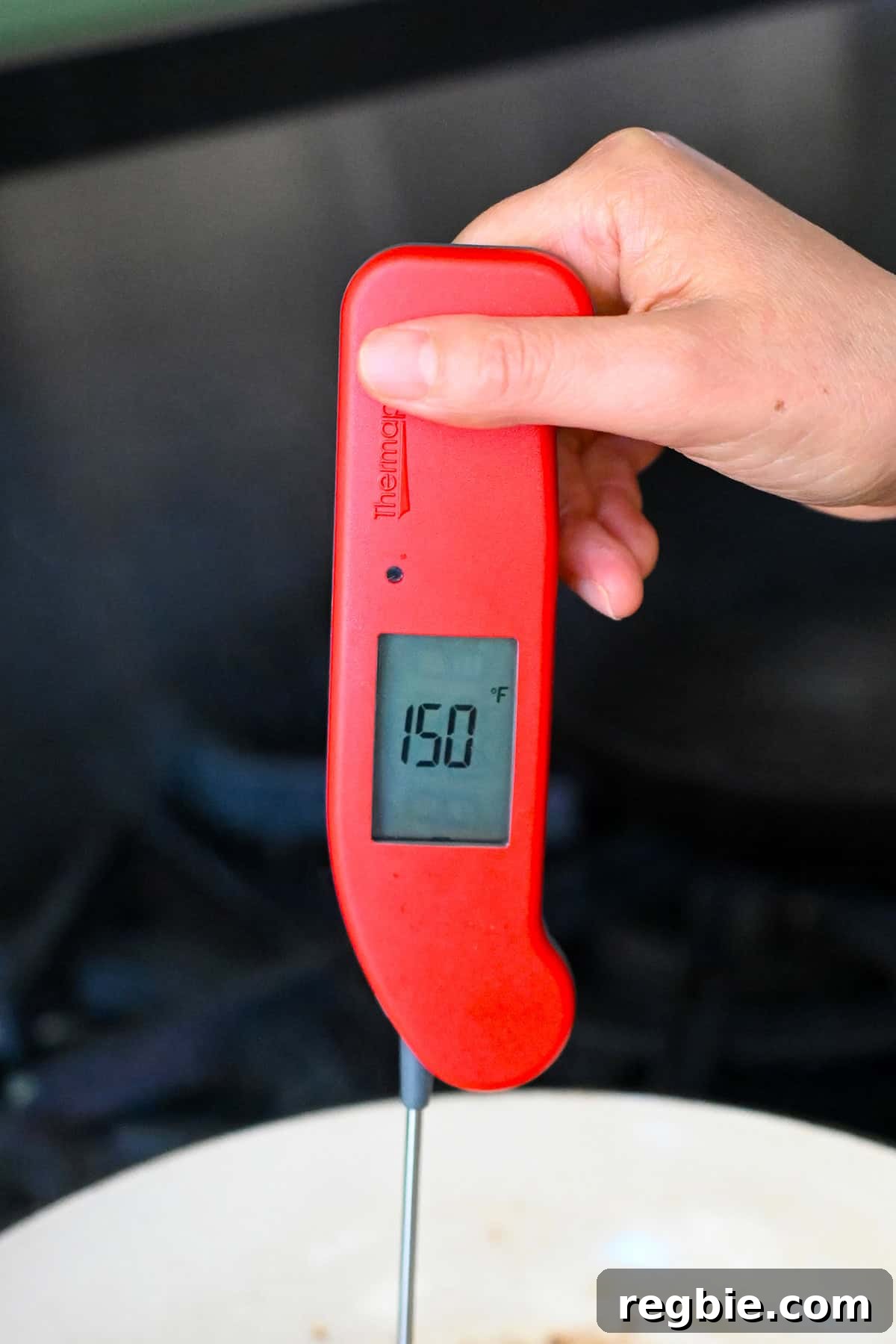 How I Cook Juicy, Tender Chicken Breasts Every Time 12 A red instant read thermometer shows 150°F on the display.